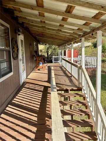 a view of a balcony with wooden floor