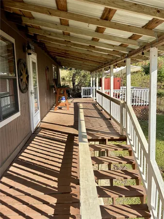 a view of a balcony with wooden floor