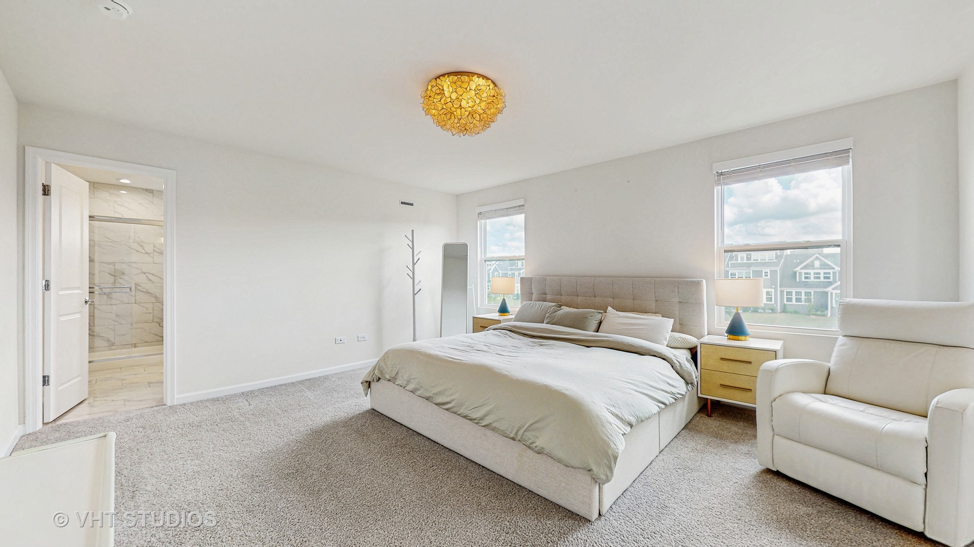 1248 Snapper Road Naperville, IL 60563 - Photo 20 of 34 a spacious bedroom with a bed a couch and window