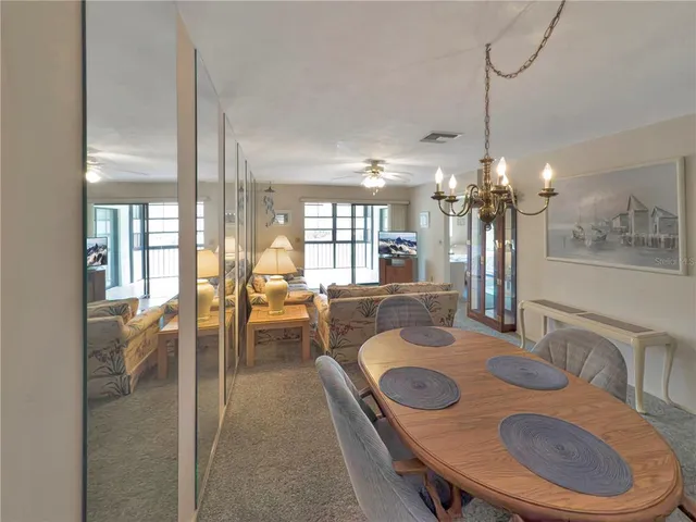a dining room with furniture and chandelier