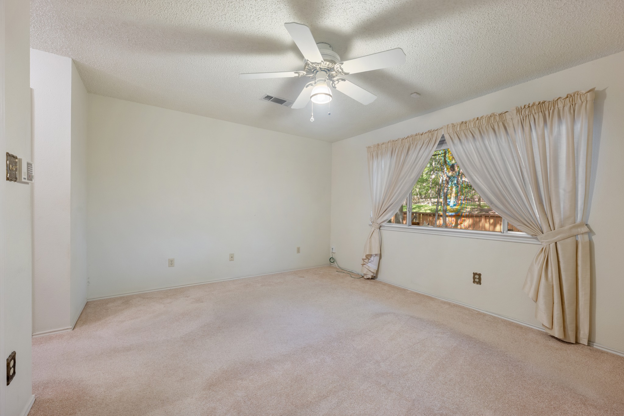 8318 Bent Tree Road Austin, TX 78759 - Photo 23 of 37 The spacious layout of the primary bedroom provides plenty of room for a full king-size furniture set