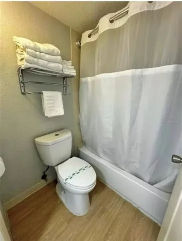 a white toilet sitting next to a shower