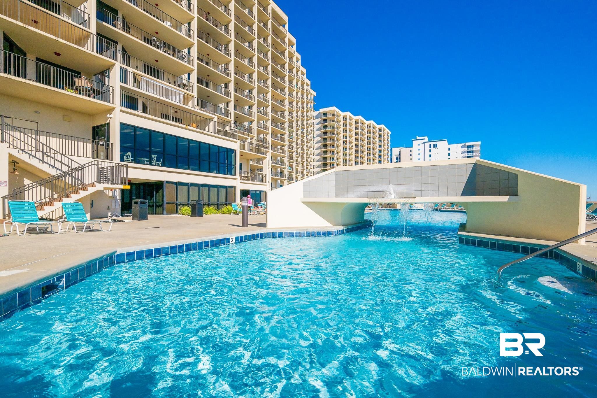 26802 Perdido Beach Boulevard, Unit 406 Orange Beach, AL 36561 - Photo 32 of 37 Community pool featuring a patio area and stairs