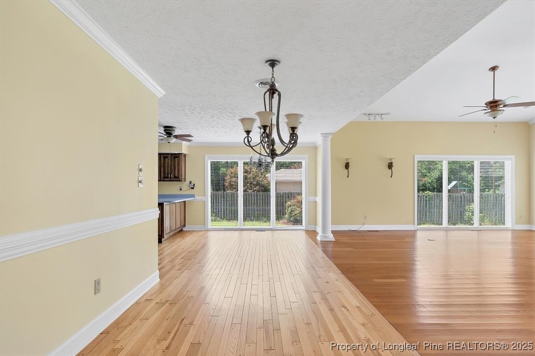 363 Bee Gee Road Lumberton, NC 28358 - Photo 14 of 45 a view of a room with wooden floor ceiling fan and windows