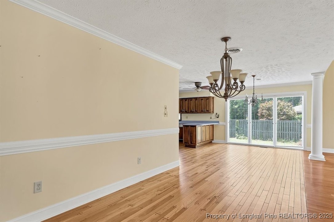 363 Bee Gee Road Lumberton, NC 28358 - Photo 15 of 45 a view of a room with wooden floor and a ceiling fan