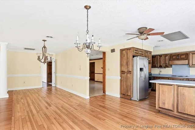a view of a kitchen with a sink and refrigerator