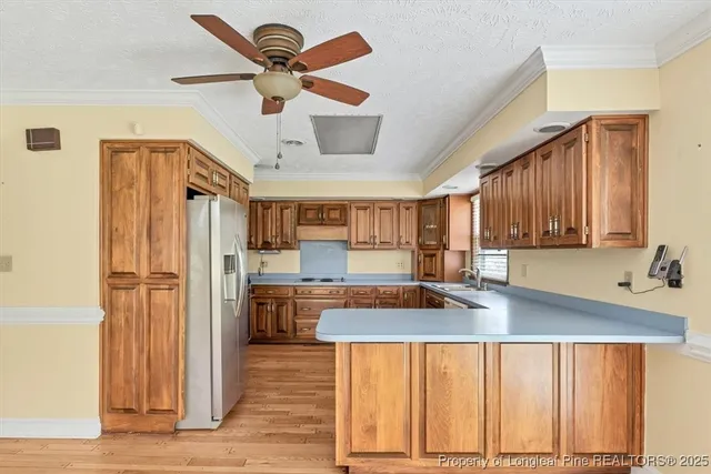 a kitchen with refrigerator and cabinets