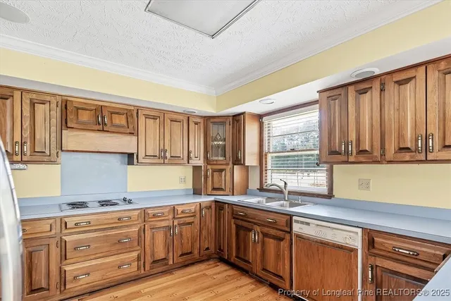 a kitchen with granite countertop wooden cabinets a sink and a window