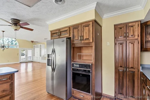 a kitchen with stainless steel appliances granite countertop a refrigerator and a stove top oven
