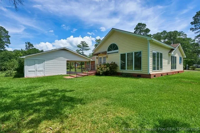 a front view of house with yard and green space