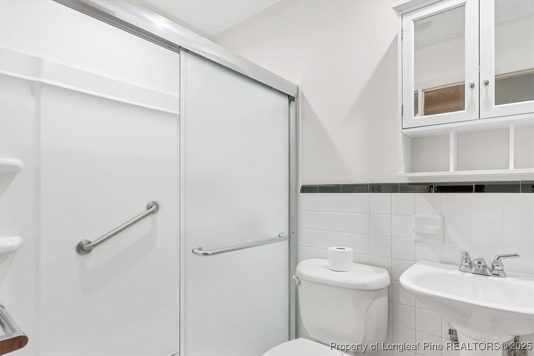 363 Bee Gee Road Lumberton, NC 28358 - Photo 31 of 45 a bathroom with a toilet a sink and a mirror
