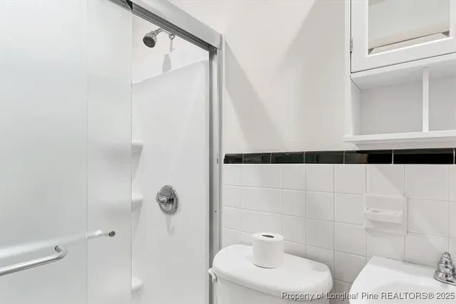 a bathroom with a toilet and a shower