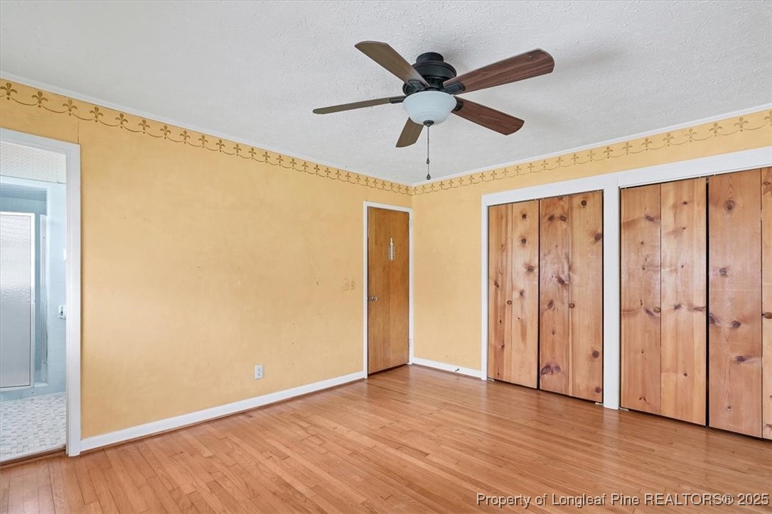 363 Bee Gee Road Lumberton, NC 28358 - Photo 34 of 45 a view of a big room with wooden floor and a ceiling fan