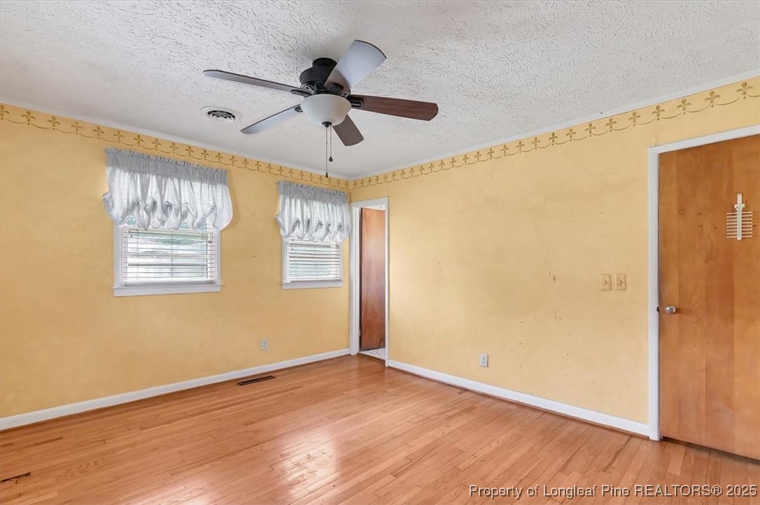 363 Bee Gee Road Lumberton, NC 28358 - Photo 36 of 45 a view of an empty room with wooden floor and a window