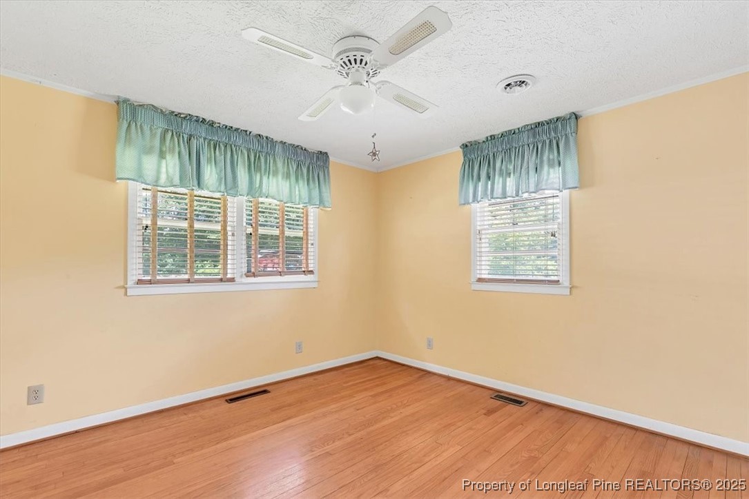 363 Bee Gee Road Lumberton, NC 28358 - Photo 38 of 45 a view of an empty room with wooden floor and a window