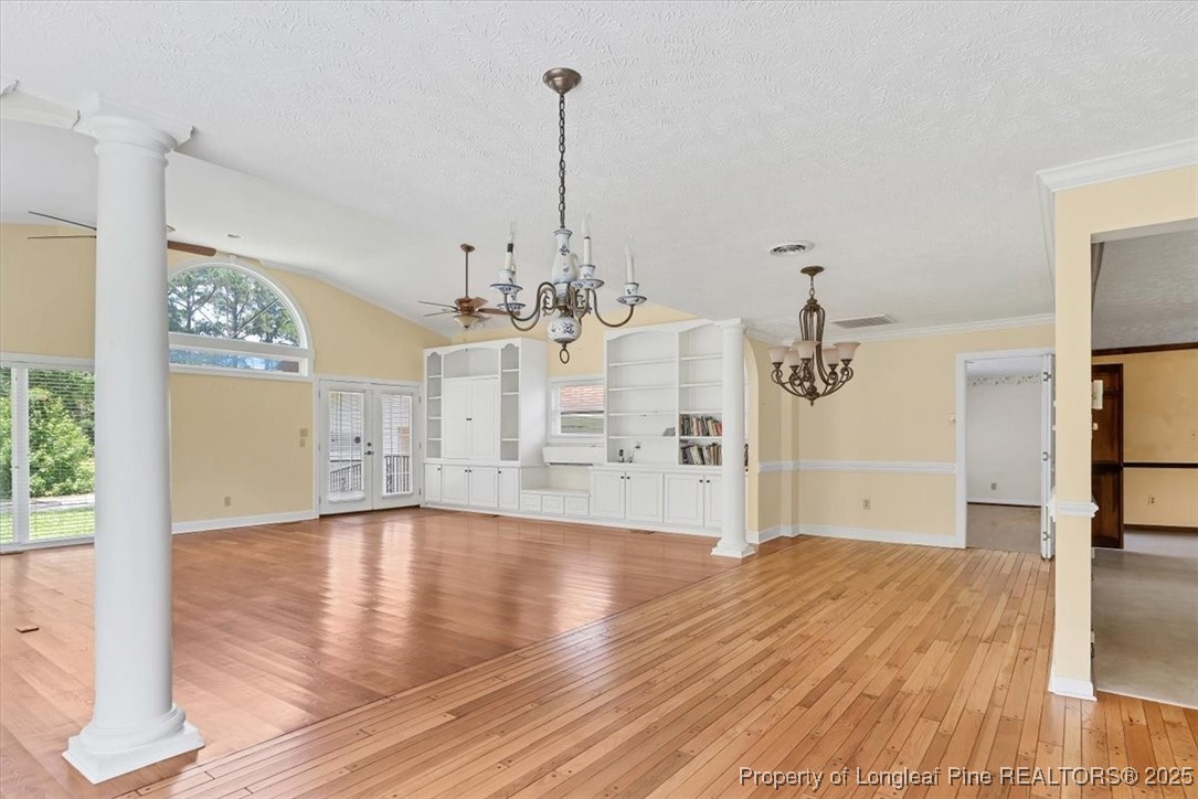 363 Bee Gee Road Lumberton, NC 28358 - Photo 6 of 45 a view of empty room with wooden floor and kitchen view