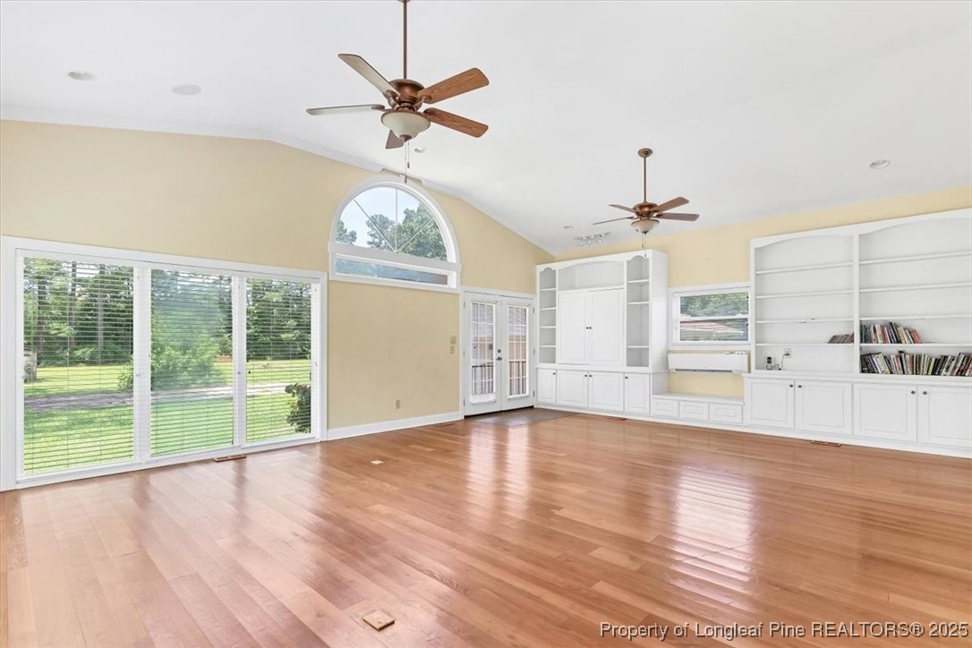 363 Bee Gee Road Lumberton, NC 28358 - Photo 9 of 45 an empty room with wooden floor fan and windows