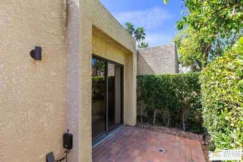 front view of a house with a tree