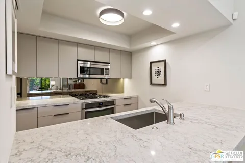 a kitchen with stainless steel appliances granite countertop a stove and a refrigerator
