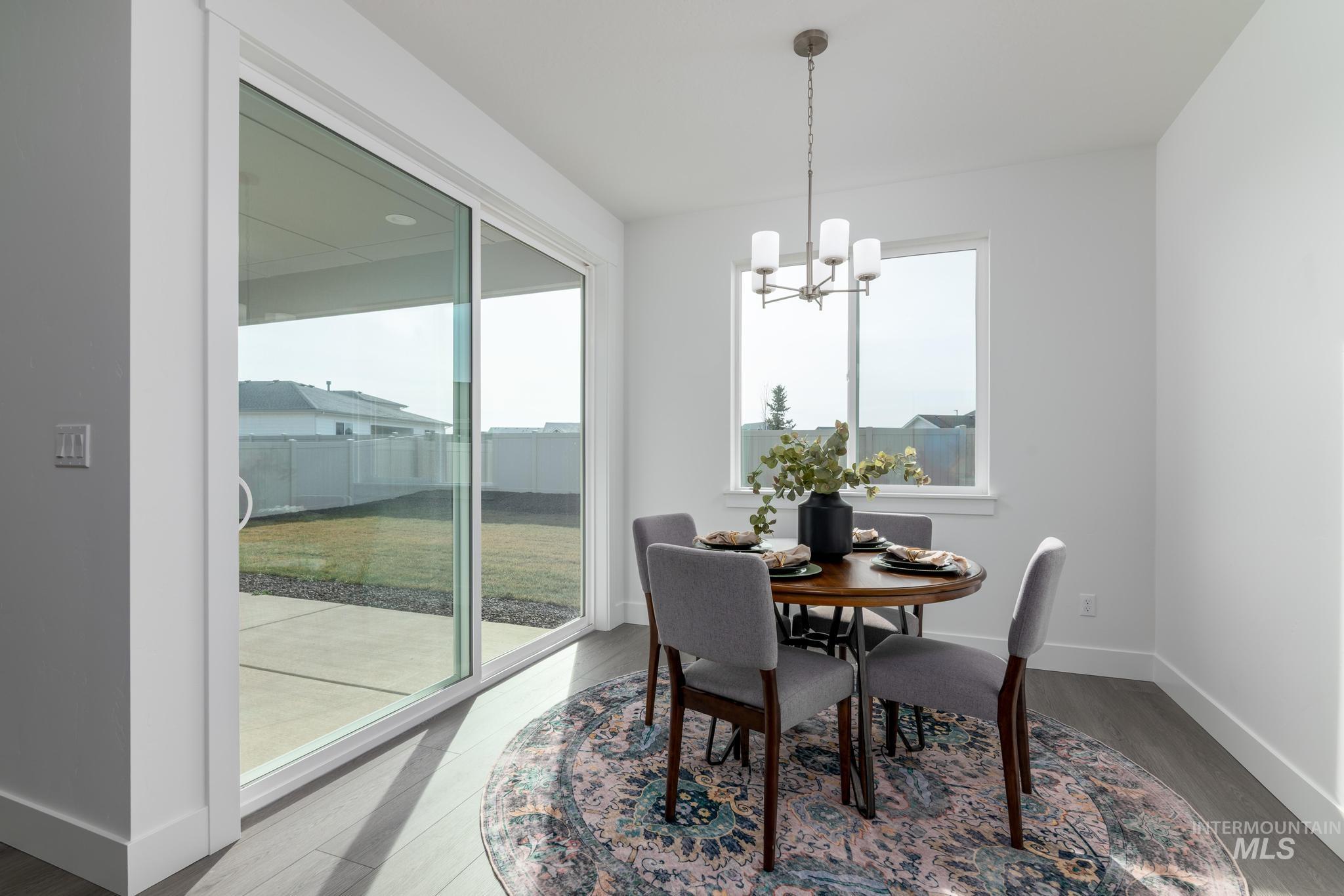 822 West Bay Street Middleton, ID 83644 - Photo 6 of 11 Dining room featuring wood finished floors and a chandelier