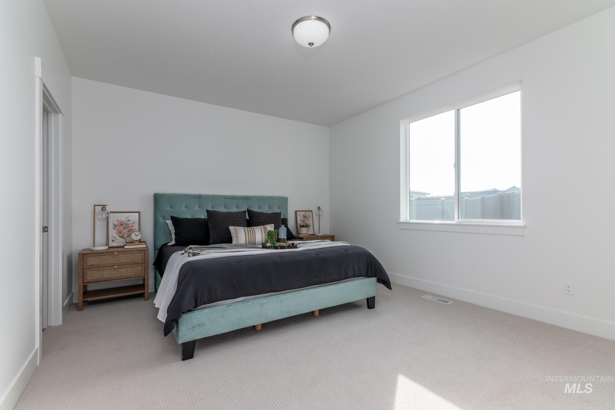 822 West Bay Street Middleton, ID 83644 - Photo 7 of 11 Bedroom featuring light carpet and baseboards