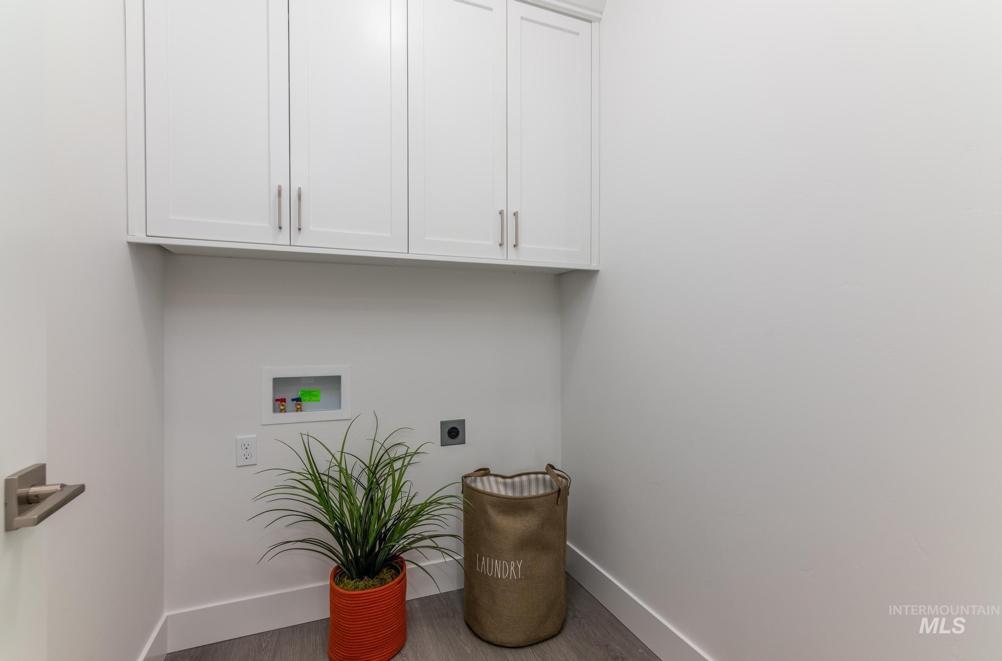 822 West Bay Street Middleton, ID 83644 - Photo 10 of 11 Laundry area with wood finished floors, cabinet space, hookup for a washing machine, and electric dryer hookup