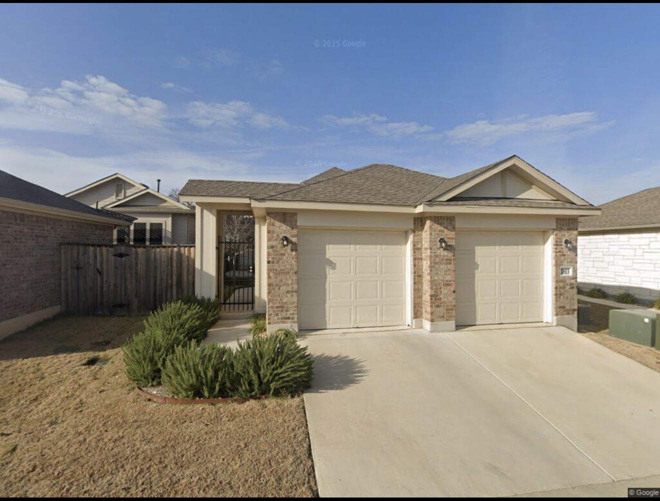 Ranch-style home with concrete driveway, a garage, brick siding, a gate, and a shingled roof