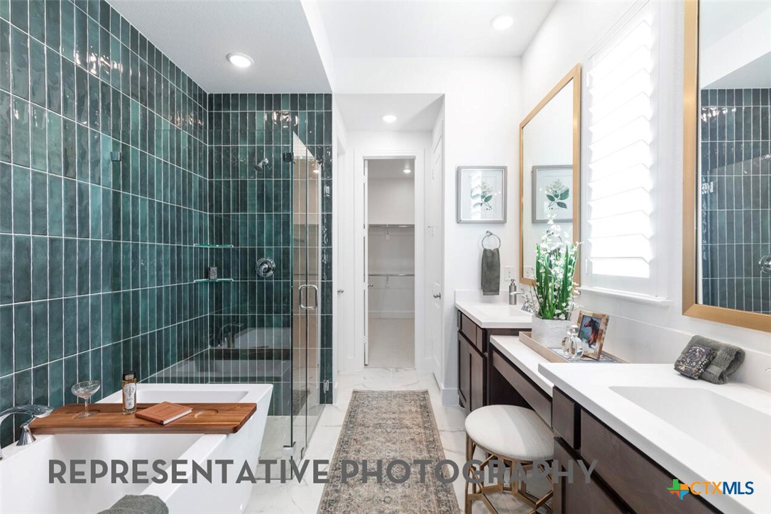 511 Fawn Ridge Cibolo, TX 78108 - Photo 11 of 22 a bathroom with a sink a toilet a mirror and shower