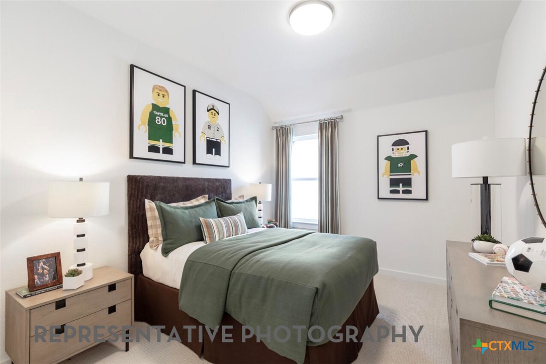 511 Fawn Ridge Cibolo, TX 78108 - Photo 16 of 22 a bedroom with a bed and a lamp on dresser