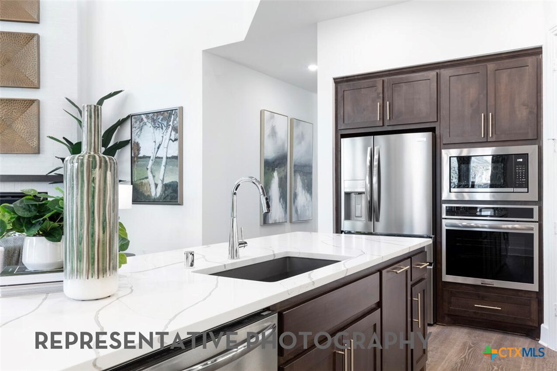 511 Fawn Ridge Cibolo, TX 78108 - Photo 5 of 22 a kitchen with stainless steel appliances a sink and a refrigerator