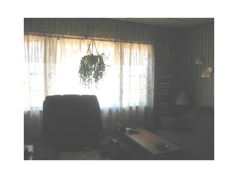 67 Bridge Street Enfield, ME 04493 - Photo 12 of 20 Living Room. large window to sider