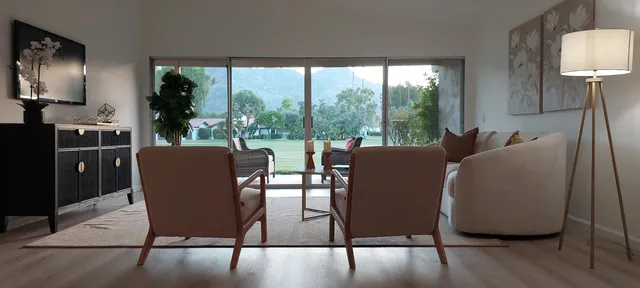 a view of a dining room with furniture a chandelier and wooden floor