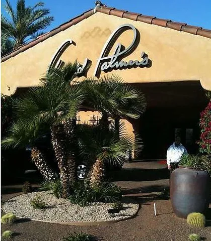 a couple of potted plants sitting in front of a house