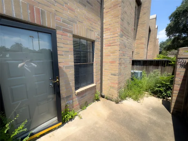 a view of a brick house with a large windows
