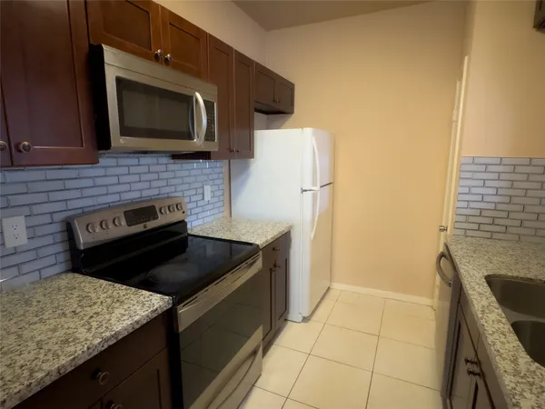 a kitchen with a stove microwave and refrigerator