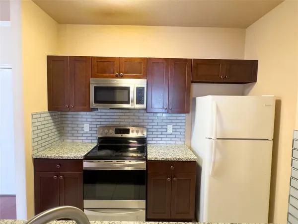 a kitchen with a sink and a refrigerator