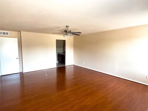 a view of a room with wooden floor