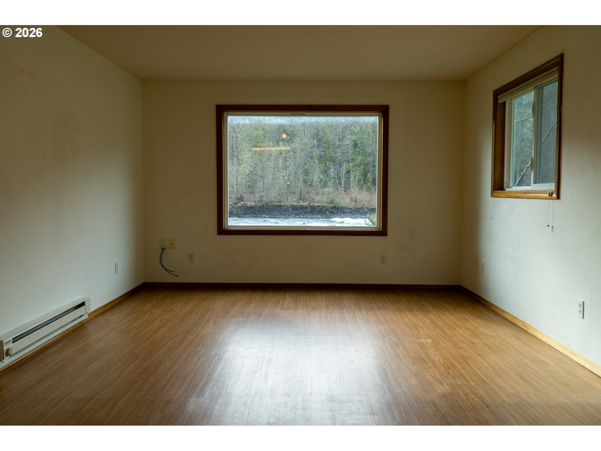 28821 Southeast Paradise Road Eagle Creek, OR 97022 - Photo 29 of 47 a view of an empty room with wooden floor and a window