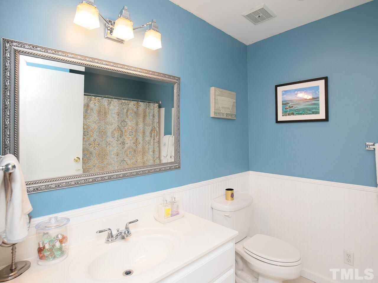 4911 Latimer Road Raleigh, NC 27609 - Photo 22 of 25 a bathroom with a sink and a bathtub