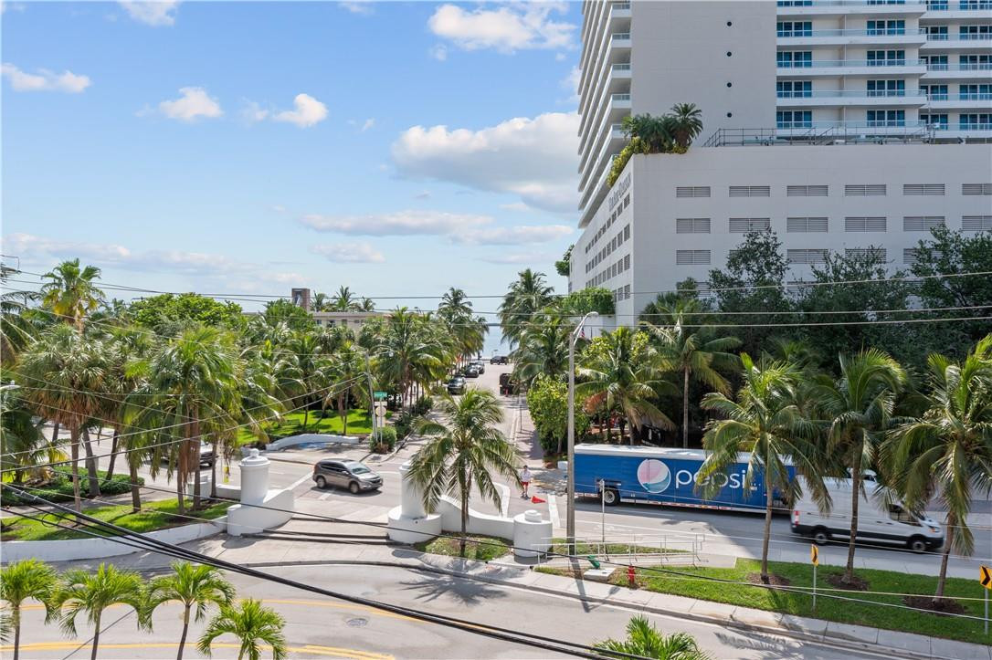 95 North Birch Road, Unit 405 Fort Lauderdale, FL 33304 - Photo 1 of 34 a view of a yard with plants and palm trees