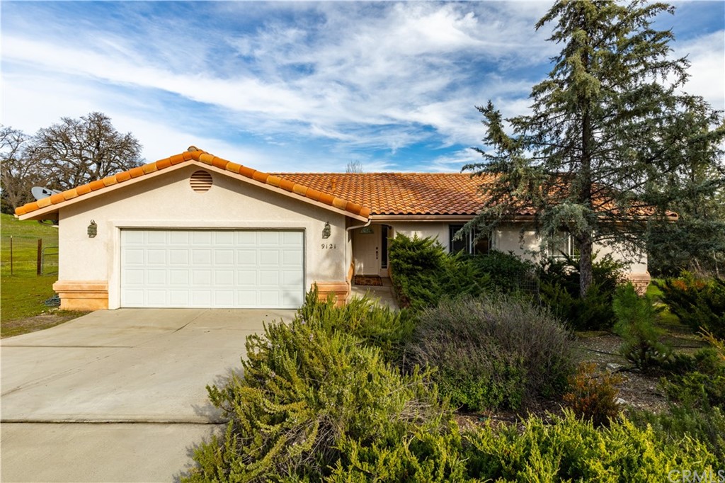 a view of backyard of house with green space