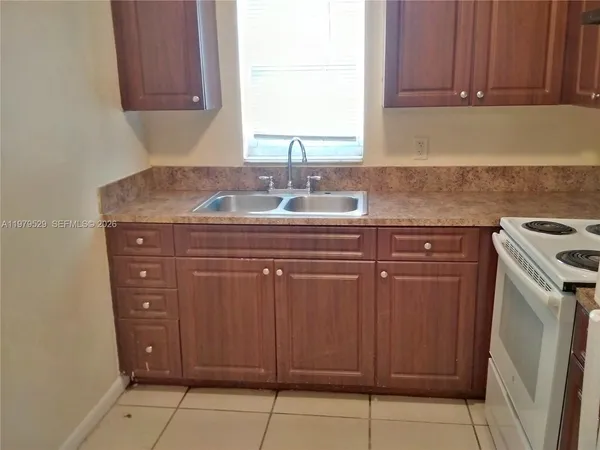 a kitchen with a sink and a stove top oven