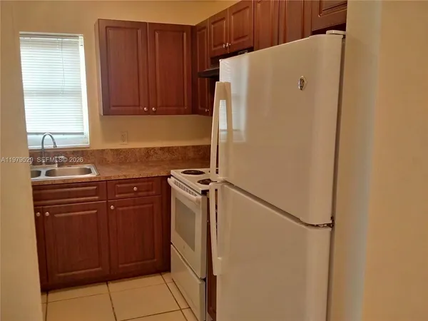 a white refrigerator freezer sitting inside of a kitchen