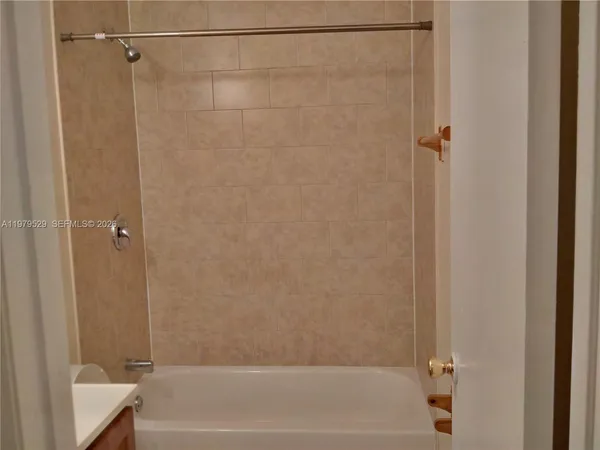 a bathroom with a shower and a bath tub