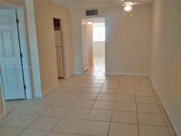 a view of a livingroom with an empty space and a window