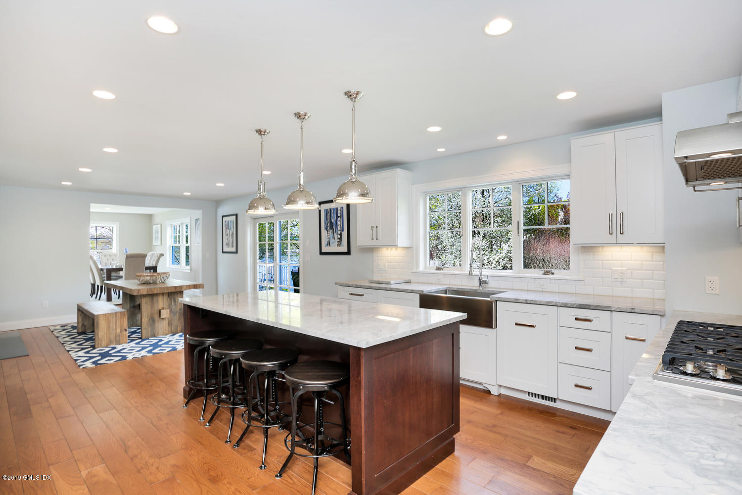 35 Chapel Lane Riverside, CT 06878 - Photo 16 of 45 a kitchen with stainless steel appliances kitchen island granite countertop a table chairs sink and cabinets