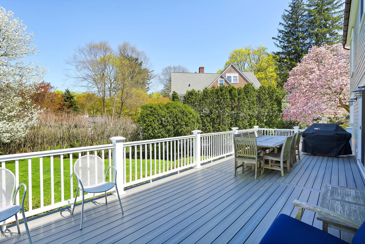 35 Chapel Lane Riverside, CT 06878 - Photo 18 of 45 a view of a deck with table and chairs and wooden floor