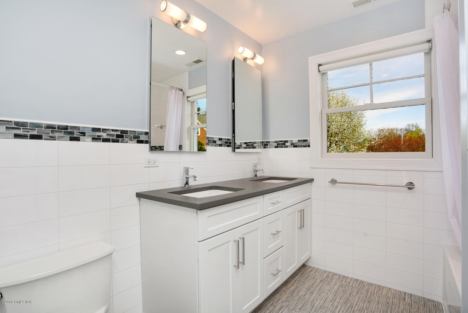 35 Chapel Lane Riverside, CT 06878 - Photo 30 of 45 a bathroom with a granite countertop sink a mirror and a shower