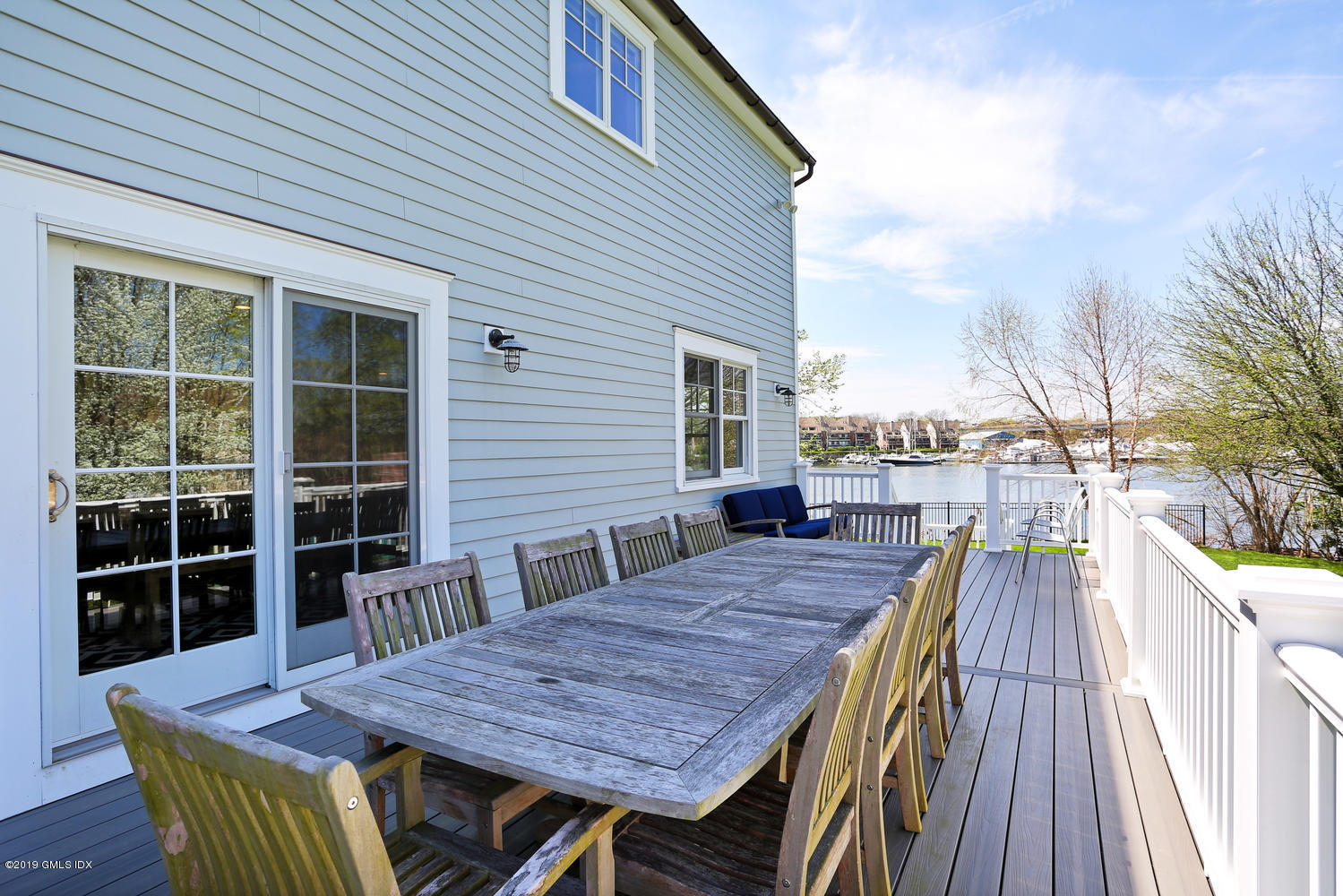 35 Chapel Lane Riverside, CT 06878 - Photo 31 of 45 a view of a roof deck with table and chairs a barbeque with wooden floor and fence
