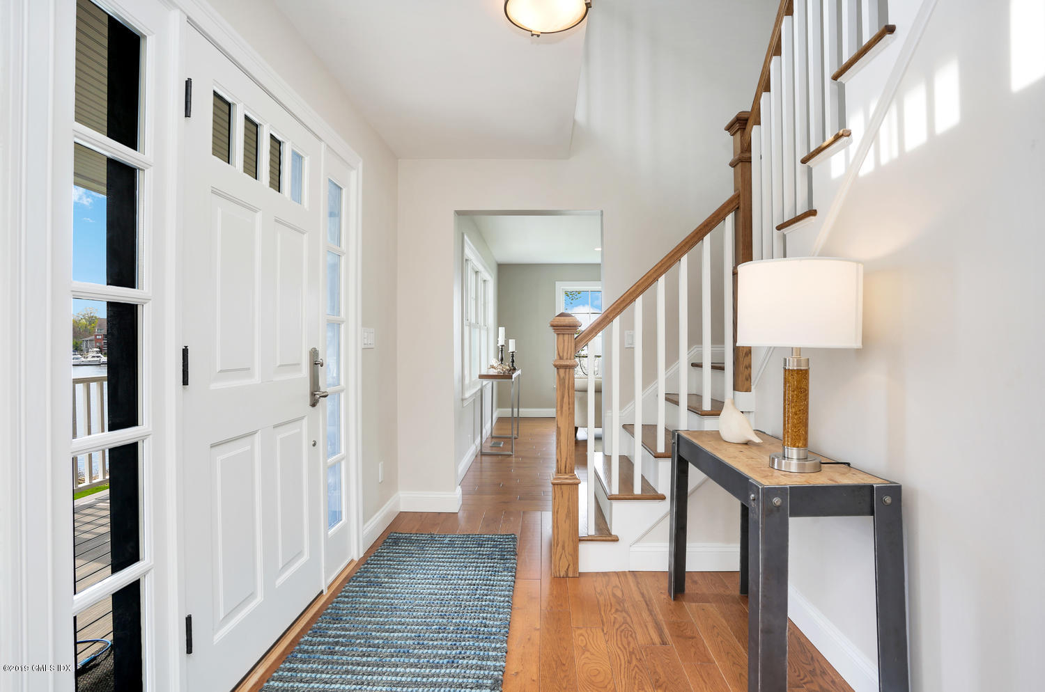 35 Chapel Lane Riverside, CT 06878 - Photo 8 of 45 a view of staircase with lots of frames on wall and wooden floor